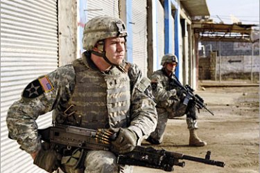 AFP / A picture released by the US military, 12 April 2007 shows US Army Spc. Douglas Harlan (L), and a fellow soldier conducting a cordon and search for weapons caches and