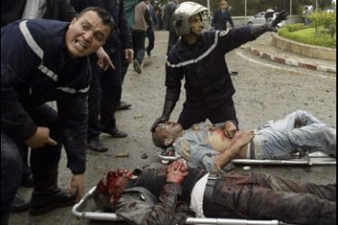 R/Firemen tend to victims of a suicide car bomb which exploded near the prime minister's headquarters in central Algiers April 11, 2007. REUTERS/Louafi Larbi (ALGERIA)