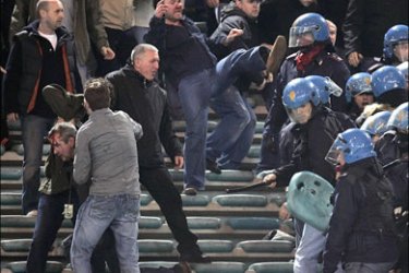 r - Italian riot policemen clash with supporters in the British section during the Champions League quarter-final, first leg soccer match between