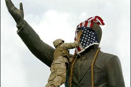 AFP / A US Marine covers the face of Iraqi President Saddam Hussein's statue with the US flag in Baghdad's al-Fardous square 09 April 2003. The world was stunned when iconic images of US marines and Iraqis pulling down a statue of Saddam Hussein flashed across