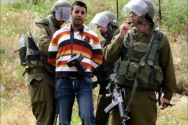Israeli soldiers arrest the Reuters staff photographer as he covers the weekly protest by foreign and Palestinian activitis agaisnt the building of the controversial Israeli separation