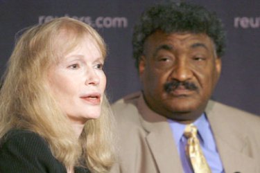 Actress and UNICEF Goodwill ambassador Mia Farrow speaks as Abdalmahmood Abdalhaleem, Sudanese Ambassador to the United Nations, looks on during a Reuters