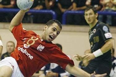 Mohamed Ahmed Ibrahim of Egypt's Al-Ahly (L) attempts to score in front of Mirza Dzomba of Spain's Ciudad Real during their match in the Super Globe Handball Championships in Cairo