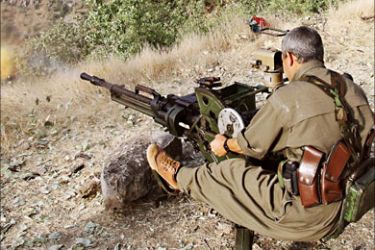 f_A Kurdistan PKK fighter fires with his '"Dorcka", a machine gun, early in the morning 20 June 2007 before a training session at Amedia area in Northern Iraq, 10 km near
