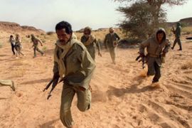 (FILES) This file picture taken 14 June 1988 in Polisario-controlled Western Sahara shows Polisario commandos scrambling to take up positions near the front line