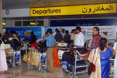 f_Travellers of various nationalities trying to return home queue at the check-in desks as Seeb International Airport reopens following a devastating cyclone, in the Omani capital