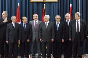 r_Palestinian President Mahmoud Abbas (C) and Salam Fayyad (7th R), the economist who becomes prime minister, stand with fellow cabinet members during a swearing