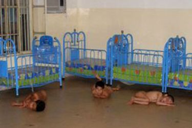 An undated handout picture obtained from the US TV news channel CBS, 20 June 2007 shows Iraqi children showing signs of severe neglect laying on the floor in a room and tied to their beds beds,