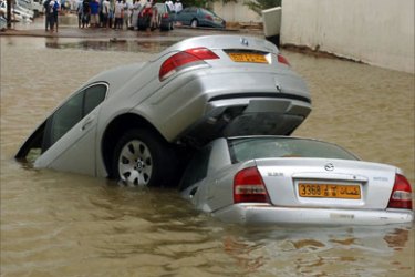 Partially submerged cars stand in a flooded street of the Omani capital Muscat, 07 June 2007.