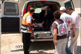 طاقم من الصليب يجهزون سيارة الإسعاف لنقل جريح الى إسرائيل من تقرير من غزة عن معاناة الجرحى الفلسطينيين.
