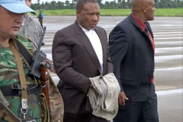 (FILES) A handout file photo released by the Special Court for Sierra Leone shows former Liberian president Charles Taylor (C) being escorted by UN officials from an helicopter to a plane for the Netherlands 20 June 2006, at Freetown airport. Taylor refused 04 June 2007 to attend the opening of his war crimes trial, saying in a letter read out in court that he could not expect a fair trial