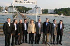 LtoR) G8 leaders pose for a family photo on the pier of the of the Kempinski Grand Hotel in Heiligendamm, northeastern Germany, following a working session