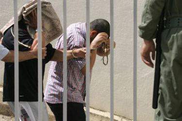 Suspects accused of planning terror attacks and having links with Al-Qaeda arrive, 22 June 2007, at the antiterrorist courthouse in Sale, near the capital Rabat, during the trial