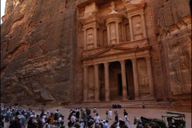 R/Tourists visit the Petra in front of the treasury site July 9, 2007. The Great Wall of China, Petra in Jordan and Brazil's statue of Christ the Redeemer are among the modern day seven wonders of the world chosen in a poll of 100 million online voters, organisers said on July 7, 2007.