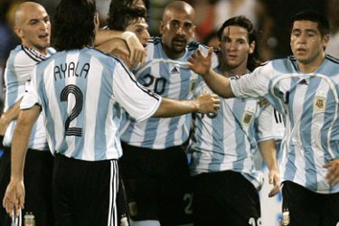 Argentina’s midfielder Juan Roman Riquelme (R) celebrates with his teammates after scoring the second goal of Argentina against Colombia during their Copa America