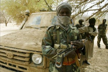 Sudanese rebel fighters from the Sudanese Justice and Equality Movement (JEM) stand guard during a visit by African Union envoy to Sudan Salim Ahmed Salim in the area of Kariarii, near the Chadian border July 8, 2007