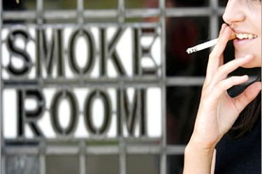 REUTERS /A women smokes a cigarette outside the Odd House public house in Snarestone, central England, July 1, 2007. With a ban on smoking in all enclosed public spaces coming into