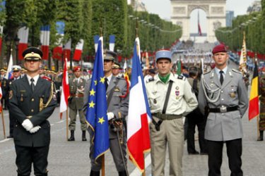AFP/ European armies soldiers hold French and European flags during the Bastille Day parade on the Champs-Elysees, 14 July 2007.