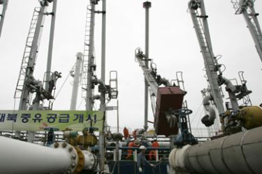 South Korean workers from SK Energy load heavy fuel oil into South Korean oil tanker "Han-chang" at a port in Ulsan, about 414 km (257 miles) southeast of Seoul,