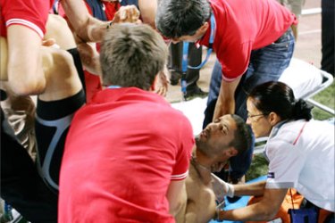 French long jumper Salim Sdiri is helped after being hit by a javeling during the Athletics IAAF Golden Gala in Rome's Olympic Stadium 13 July 2007
