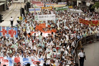 Pro-democracy protesters take part in a protest march demanding universal suffrage in Hong Kong July 1, 2007, marking the 10th anniversary of Hong Kong's handover to Chinese rule.