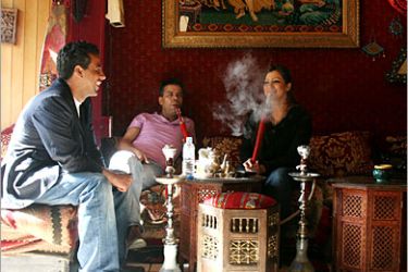 AFP - Customers at the Mamounia Lounge, a cafe in west London smoke a Shisha 26 June 2007. Businesses that offer customers shisha water pipes to smoke tobacco are waging an 11th-hour bid for an exemption to a smoking ban that
