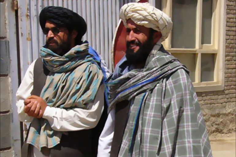 Taliban negotiators Qari Bashir (L) and Mawlavi Nasrullah exit the Afghan Red Crescent Society of Ghazni province to speak to the media August 11, 2007.
