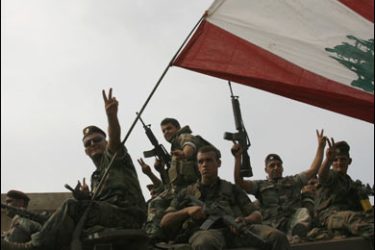 R/Lebanese soldiers flash victory signs from their armoured personnel carrier at an entrance of the Nahr al-Bared refugee camp in north Lebanon September 3, 2007. Lebanese troops on Sunday seized control of a Palestinian refugee camp