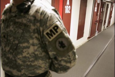 r/A U.S. Army guard stands in a corridor of cells in Camp Five, a detention facility at the Guantanamo Bay Naval Station in Guantanamo Bay, Cuba in this September 4, 2007