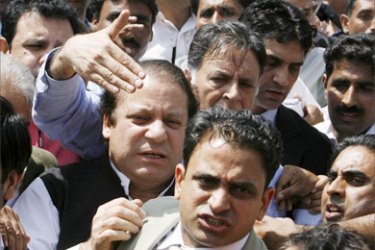 Former Pakistani prime minister Nawaz Sharif is guided as he makes his way through a crowd after disembarking from an aircraft upon arrival in Pakistan's capital Islamabad, September 10, 2007