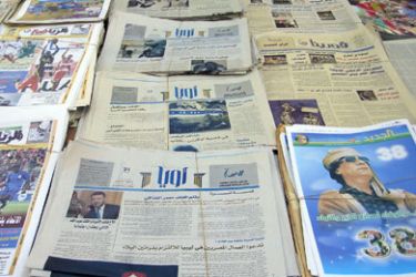 Copies of two new non-governmental Libyan newspapers, Oea (C) and Cyrene (R top and middle rows) lie ready for sale on a news