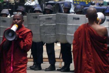 af p : Monks speak to a crowd of monks and onlookers in front of riot police during a protest in Yangon September 26, 2007. At least two Buddhist monks were killed in Myanmar's