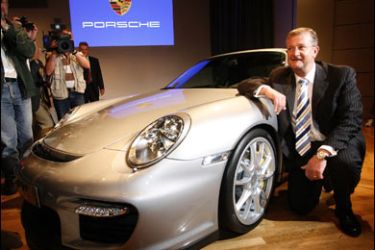 r/Wendelin Wiedeking, CEO of Porsche AG, poses beside a Porsche GT 2 before a news conference at the Frankfurt International Auto Show IAA in Frankfurt September 11, 2007