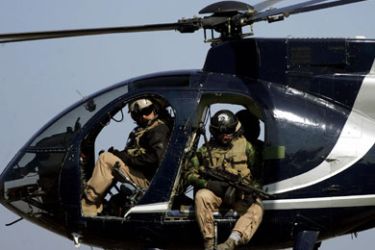 AFP/ in a file picture dated 05 February 2005, members of the US-based Blackwater private security firm scan Baghdad city centre from their helicopter. Iraq's interior minister Jawad al-Bolani 17 September 2007