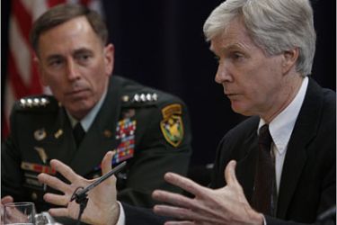 REUTERS/General David Petraeus, the U.S. commander in Iraq (L), listens to Ryan Crocker, U.S. Ambassador to Iraq,