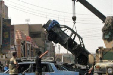 afp : A crane lifts a burnt car at the site of a car bomb explosion in Baghdad's Sinaa Street, near the University of Technology University, 08 October 2007.Four people were