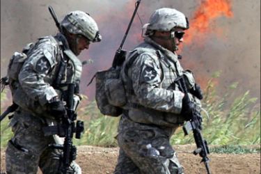 afp : US soldiers from Alpha Company, 1/38 Infantry Regiment move past a fire set to clear undergrowth during a clearing operation outside Baquba, 08 October 2007, some
