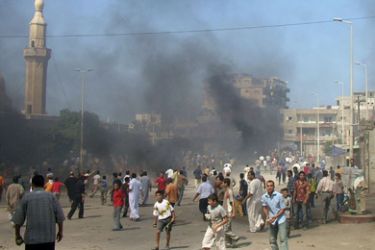 Smoke rises from burning palm fronds during a protest in the town of El-Arish October 7, 2007. Police used tear gas against hundreds of Bedouin in an Egyptian border town