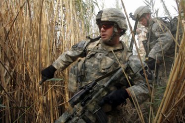 AFP/ US army soldiers of Alpha Company, 1/38 Infantry Regiment, search through the bushes after their Stryker convoy was targeted by an IED, 5 miles south of Baquba, 05 October 2007.