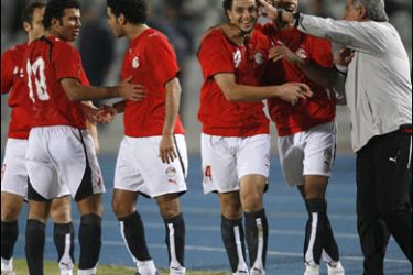 F/Egyptian players celebrate with their coach Hassan Shehata (R) after scoring a goal during their final football match against Saudi Arabia at the 11th Pan Arab Games in Cairo, 25 November 2007. AFP PHOTO/KHALED DESOUKI