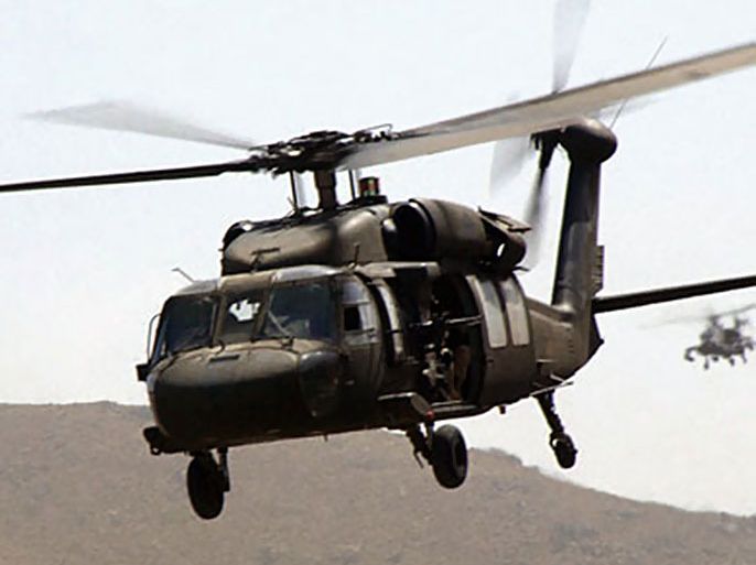 A picture taken 08 August 2004 released 08 November 2007 shows a US Army UH-60 Blackhawk helicopter transporting Soldiers over the mountains of Jikdalek, Afghanistan.
