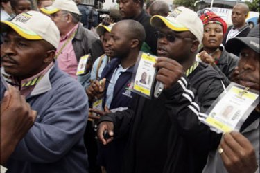 r : African National Congress (ANC) delegates show their accreditations to security before casting their votes during the third day of the ANC conference in Polokwane,