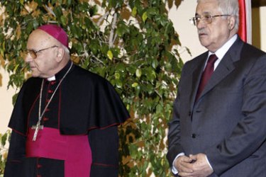 The Latin Patriarch of Jerusalem Michel Sabbah (L) and Palestinian President Mahmoud Abbas stand together during their meeting in the West Bank city of Bethlehem