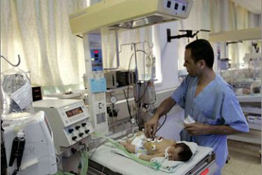 REUTERS/Salem al-Masri lies in the European hospital in the Gaza Strip December 2, 2007. Born last week with a heart defect, Masri needs life-saving surgery