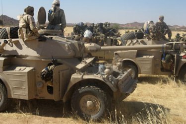 ف-Chadian soldiers ride on armoured vehicles 06 December 2007 south of the Kapka mountain range in the east of the