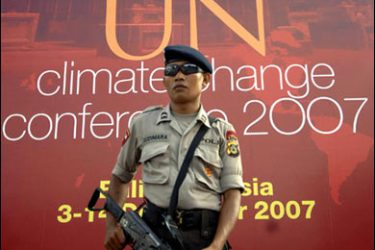 F/An Indonesian policeman stands guard in front of a banner for the upcoming Climate Change Summit in Nusa Dua, 28 November 2007 ahead of the summit meeting in Bali on 03-14 December. Indonesia's poor will be most affected by climate change, the United Nations Development Programme said in a report. AFP PHOTO/SONNY TUMBELAKA