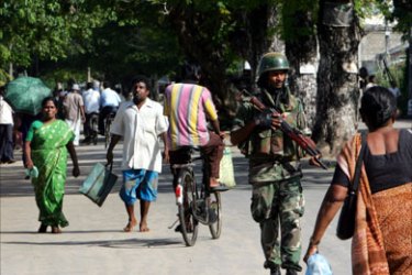 In this photograph dated 28 November 2007, a Sri Lankan soldier walks along the streets of Jaffna