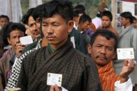 Bhutanese citizens show their voter identity cards as they queue up to cast their votes in general elections at Pashaka polling station in Jaigaon, some 45kms from the Indo-Bhutanese border, 31 December 2007.