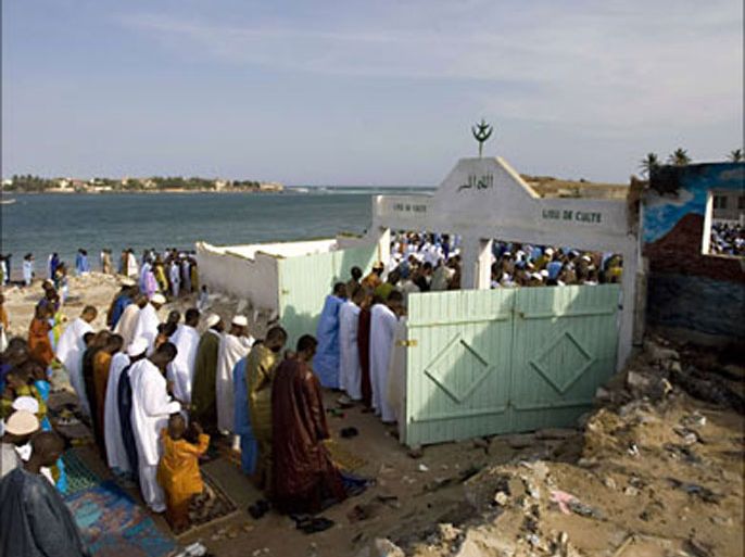r_Villagers pray at the local mosque during Tabaski celebrations in N'Gor village near Dakar December 21,2007. On Eid al-Adha, also known as Tabaski in West Africa