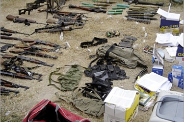REUTERS/ Confiscated weapons and other belongings are displayed at the police headquarters in Najaf, 160 km (100 miles) south of Baghdad, January 19, 2008. Iraqi security forces have